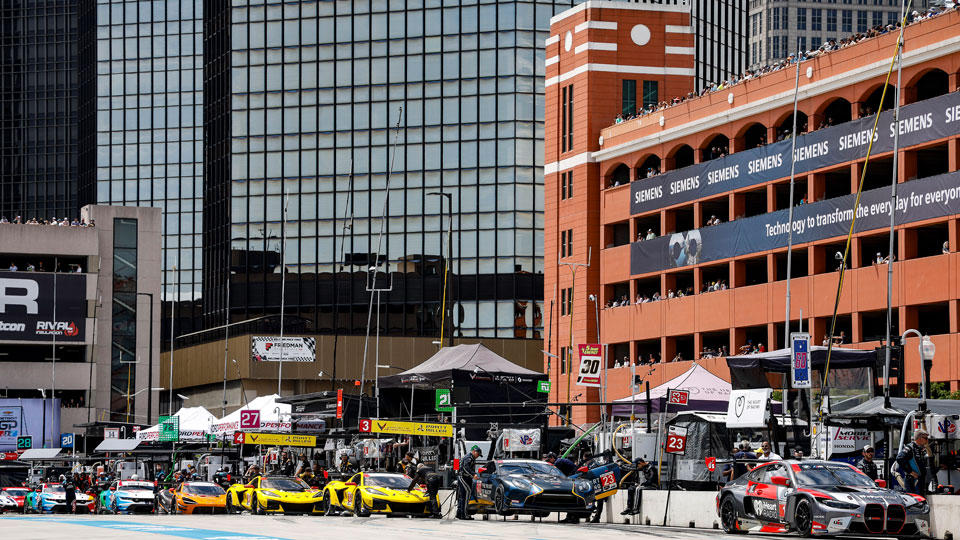 Cars on pit road in front of the Franklin Garage