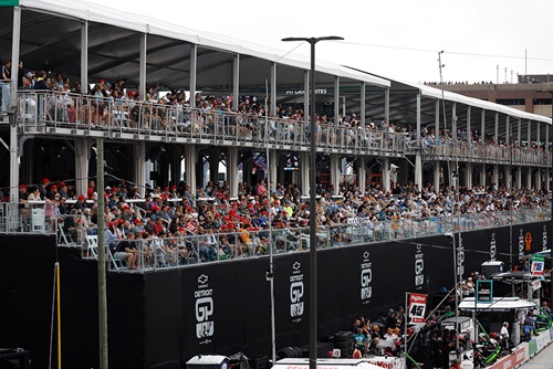 An exterior view of the Pit Lane Suites with fans on race day