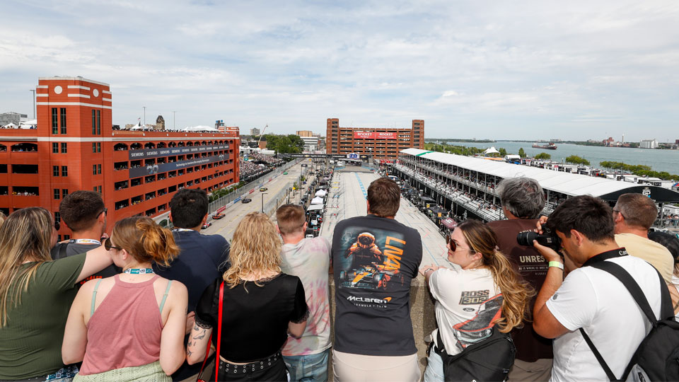 Fans watch action on the front straight and pit road from the rooftop