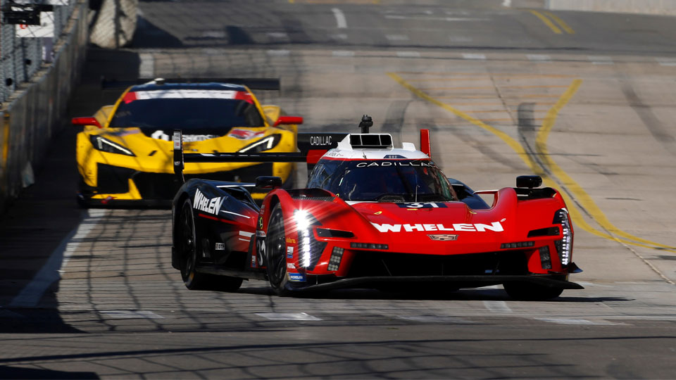 Cadillac leads the Corvette into the turn while competing in the 2024 IMSA event